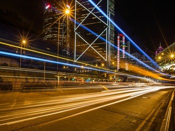 hong kong business district at night with light track