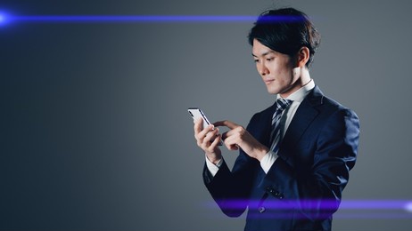
standing figure of a businessman using a smartphone