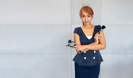 portrait of make up artist asian woman with makeup brushes.