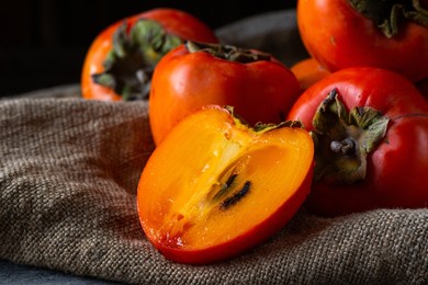 ripe persimmon on wooden background. date-plum or sharon fruit. kaki persimmon fruit. local food
