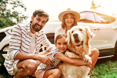 the whole family came to nature for the weekend. mom and dad with their daughter and a labrador dog are standing near the car. leisure, travel, tourism.
