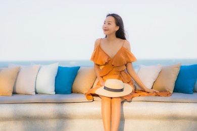 portrait beautiful young asian woman happy smile around sea ocean beach and blue sky for leisure travel vacation