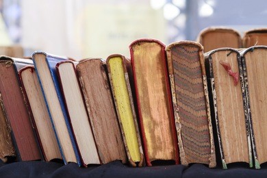 second hand books leaning against each other for sale in a street book market