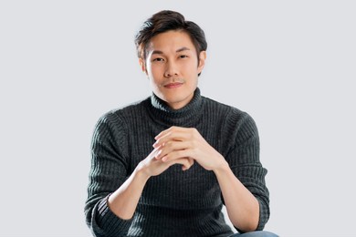 portrait lifestyle studio shot white background of young smart active asian male wear sweater smile with positive emotion and confident relax casual asian male white background