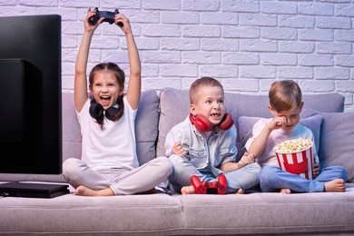 children playing video game with game console