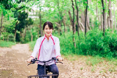 a young woman enjoying cycling in the nature