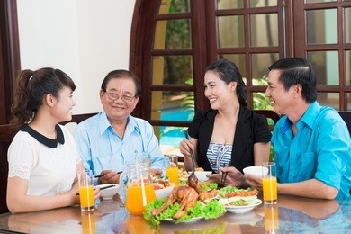 asian family talking during the dinner