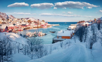 beautiful winter scenery. sunny morning scene of lofoten islands. amazing snowy cityscape of sorvagen town, norway, europe. splendid morning seascape of norwegian sea.