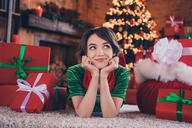 photo of charming pretty young woman dressed green costume smiling arms cheeks lying floor indoors room home house
