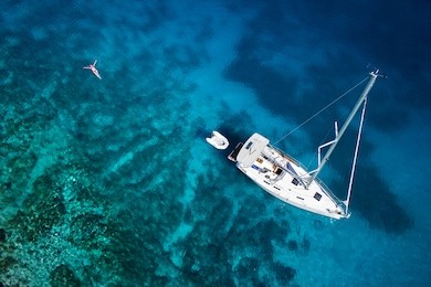 amazing view to yacht, swimming woman and clear water caribbean paradise