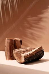 natural wood podium with tropical leaves shadow in the background. beautiful background from natural materials