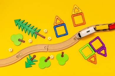 kindergarten background with constructor, toy railroad, train and toys on a yellow background. educational games. montesori. copy location