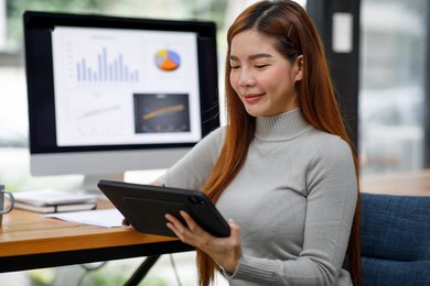 young business asian woman working on a laptop computer in a modern office,doing finances, accounting analysis, report data pointing graph freelance education and technology concept.