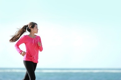 happy healthy girl running on the beach