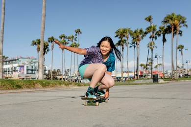 happy girl skateboarding, fun outdoors sport activity