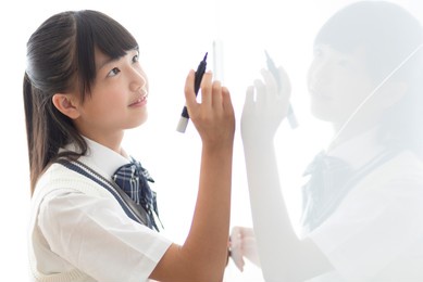 junior high school students writing on the whiteboard