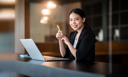 portrait of young asian businesswoman hand freelancer is working her job on computer tablet in office. doing accounting analysis report real estate investment data, financial and tax systems concept.