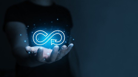 hand holding circular economy symbol. futuristic circular economy concept.sustainable strategy to eliminate waste and pollution in modern environment.renewable material resources