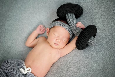 exercise baby weight lifting with dumbbells.