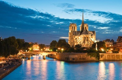 pretty evening illuminations of the stunning notre-dame cathedral (1163) and parisian apartments along the banks of the river siene, paris.