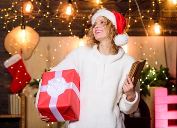 christmas bucket list. to do list concept. make your own printable checklist of christmas adult activities. girl santa hat preparing checklist. woman hold bunch of letters bills or to do list plans