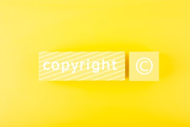 minimal trendy copyright and patenting concept. copyright word and symbol on yellow blocks against yellow background