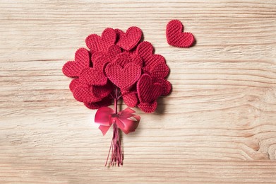 knitted love hearts on a wooden background, valentines day post card concept
