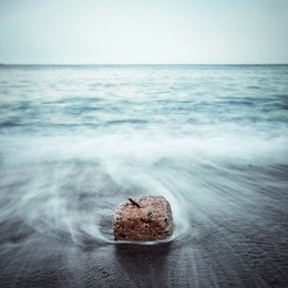 minimalist misty seascape with rocks at long exposure