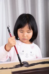 chinese girl is practicing using brush