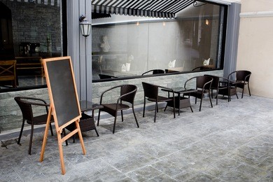 concept and design front of coffee shop with black board and black seating