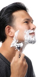 asian man shaving the beard with a razor.