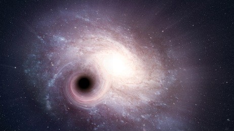 view of a large spiral galaxy and a black hole