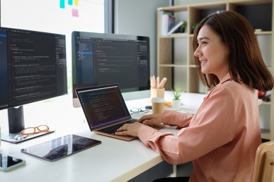 asian female programmer working at at modern office. developing programming.