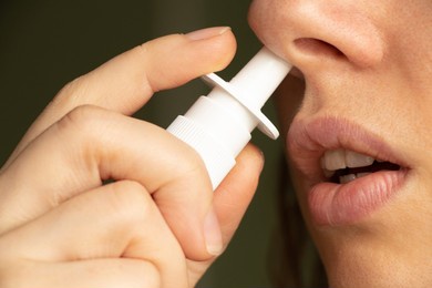close-up of unrecognizable woman who about to use nasal spray