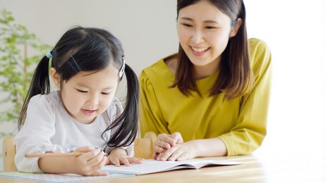 a child studying in the living room