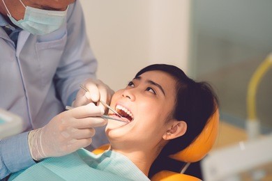 close-up of vietnamese woman having her teeth examined by specialist