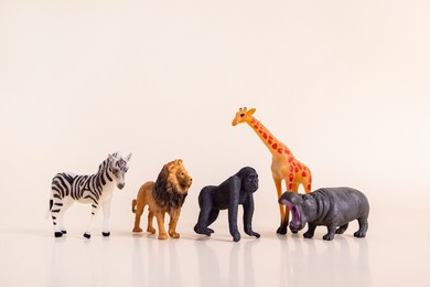 group of plastic toy animals, elephant, tiger, lion and cheetah - miniature plastic toy animals 
