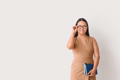 asian female teacher on light background