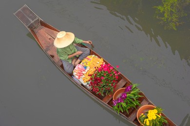 damnoen saduak floating market famous place of asian tourist attraction destination. local people sell fruits, traditional food on boats on canal, ratchaburi, thailand. concept aerial view.