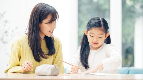 asian little girl and mother studying at home. education concept.