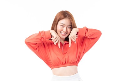 beautiful asian woman wearing casual clothes smile and pointing finger at copy space isolated on white background studio portrait.
