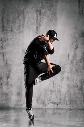 young street style dancer posing on studio background