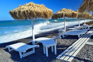 unique black pebble beach in kamari, santorini