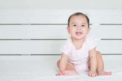 asian cute girl baby is smiling in bedroom