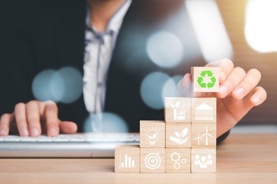 esg concept of environmental, busineewoman hand holding wooden cube block with esg icon with copy space, social and corporate governance concept