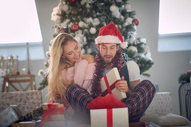 happy caucasian couple exchangingxmas gifts on a xmas morning