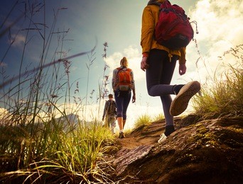 group of hikers walking in mountains