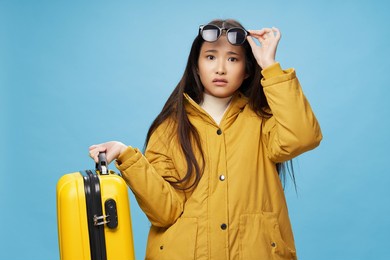 pretty woman with suitcase in winter clothes vacation travel