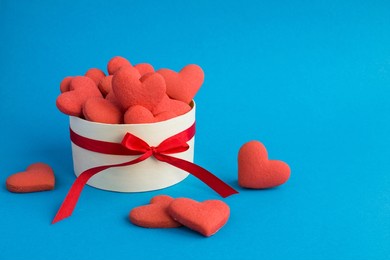 gift box with red hearts shaped cookies on the blue background.copy space.