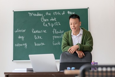 asian teacher conducting english lesson online